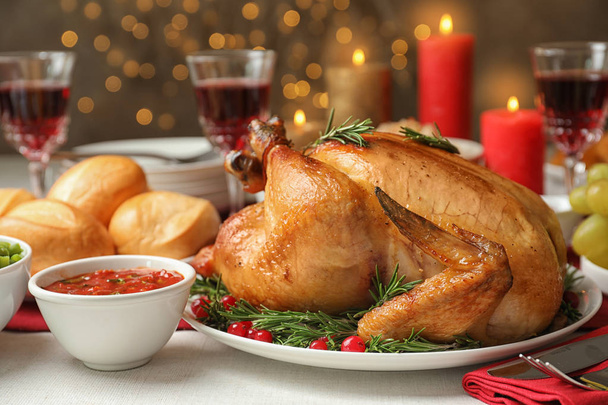 Traditional festive dinner with delicious roasted turkey served on table - Foto, imagen
