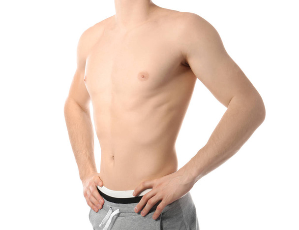 Young man with slim body on white background, closeup - Foto, imagen