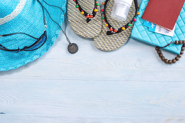 Reisezubehör: Hut, Sonnenbrille, Flip Flops, Kamerapass auf blauem Hintergrund. auf eine Reise ans Meer - Foto, Bild