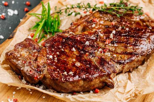 Beef rump steak from marble beef medium rare with sauce on wood  - 写真・画像