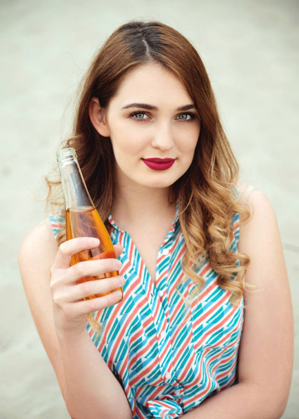 Young beautiful woman holding bottle  - 写真・画像