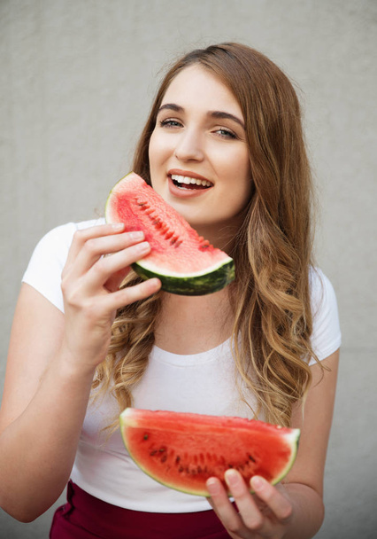 Young beautiful woman holding watermelon slices  - Фото, зображення