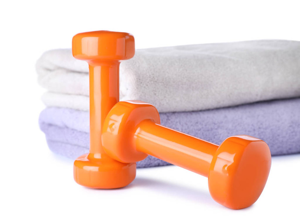 Stylish dumbbells and towels on white background. Home fitness - Fotografie, Obrázek