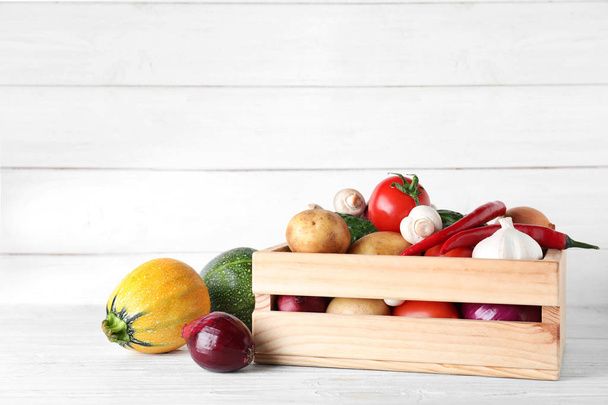 Wooden crate full of fresh vegetables on table. Space for text - Φωτογραφία, εικόνα