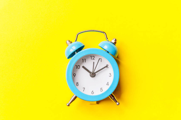 Ringing twin bell vintage classic alarm clock Isolated on yellow colourful trendy modern background. Rest hours time of life good morning night wake up awake concept - Photo, Image