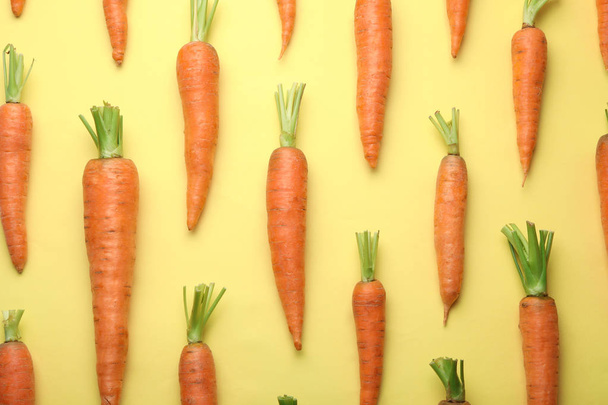 Flat lay composition with fresh carrots on color background - Zdjęcie, obraz