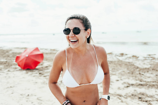 Pretty girl having fun on tropical beach - Фото, изображение