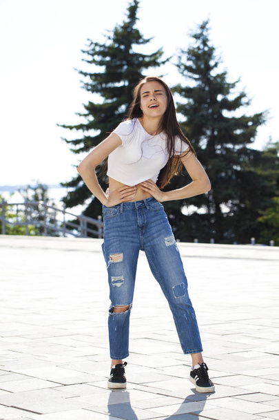 Young beautiful teenager girl posing against summer park, bright - Фото, зображення