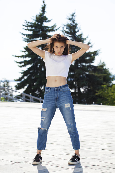 Young beautiful teenager girl posing against summer park, bright - Foto, immagini