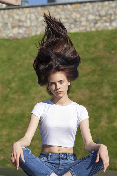Young beautiful teenager girl posing against summer park, bright - Fotoğraf, Görsel