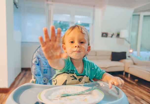 Маленька дитина їсть їжу руками
 - Фото, зображення