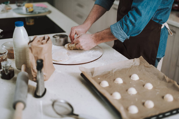 Man standing near the table and making pastry - Photo, image