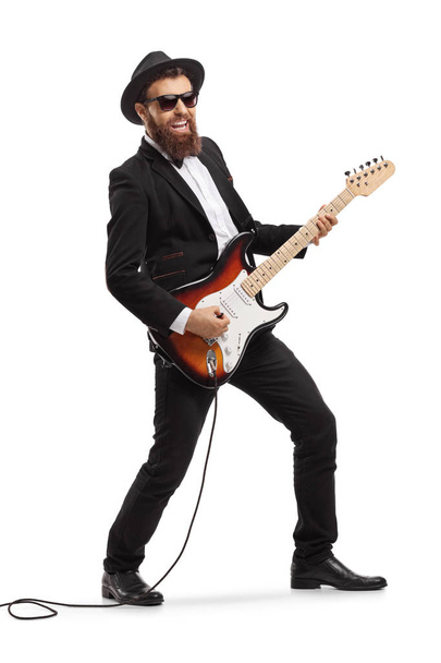 Bearded man playing an electric guitar  - Foto, afbeelding