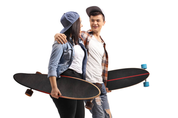 Young male and female skaters with longboards talking to each ot - Fotoğraf, Görsel