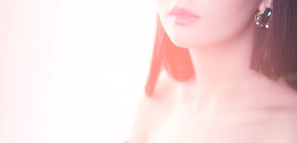 Closeup portrait of woman with makeup brush near face - 写真・画像