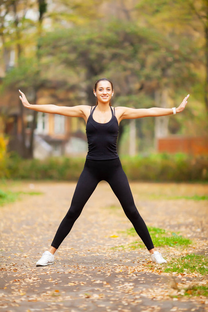 Fitness. Woman doing stretching exercise on park - Fotó, kép