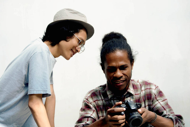 two friend of asian and black man using camera - Photo, Image