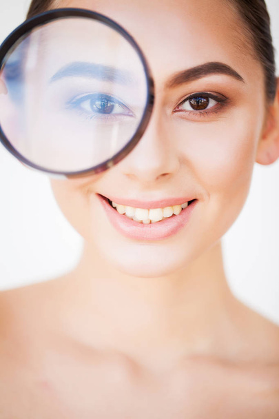 Woman Looking Through Magnifier And Smiling Close Up - Photo, Image