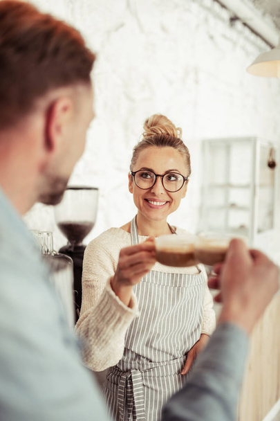 Beautiful woman drinking coffee with her husband. - Zdjęcie, obraz