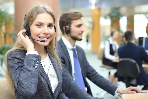 Female customer support operator with headset and smiling. - Fotoğraf, Görsel