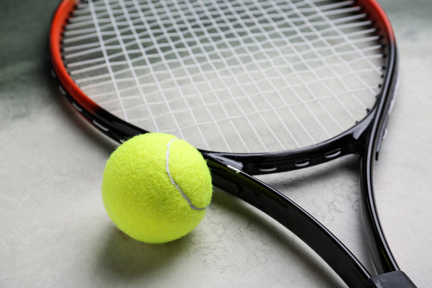 Tennis racket and ball on color background, closeup - Photo, Image