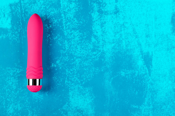 Pink vibrator on blue dirty painted background - Foto, immagini