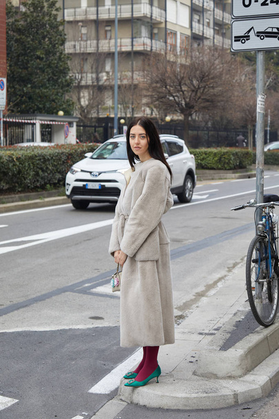 Woman with beige fur shirt and skirt and green shoes before fashion Albino Teodoro show, Milan Fashion Week street style on February 21, 2018 in Milan. - Foto, Bild