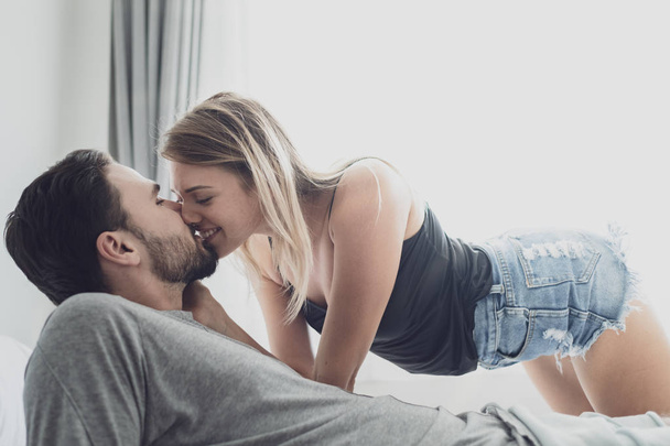 Loving happy couple in love smile kissing and hug each other on  - Фото, изображение