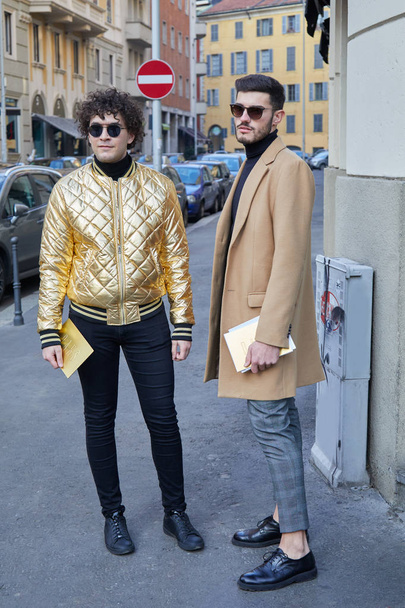 Men with golden bomber jacket and beige coat before Daks fashion show, Milan Fashion Week street style on January 14, 2018 in Milan. - Zdjęcie, obraz