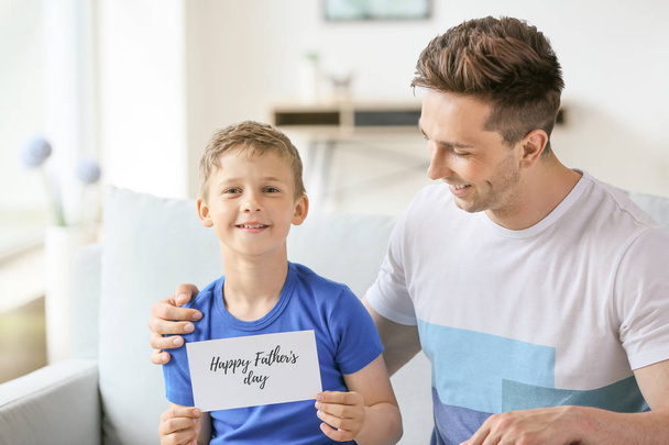 Little boy greeting his dad with Father's Day at home - Foto, Imagem