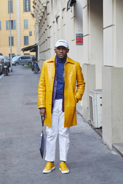 Man with yellow leather jacket and white cap and trousers before Daks fashion show, Milan Fashion Week street style on January 14, 2018 in Milan. - Fotoğraf, Görsel