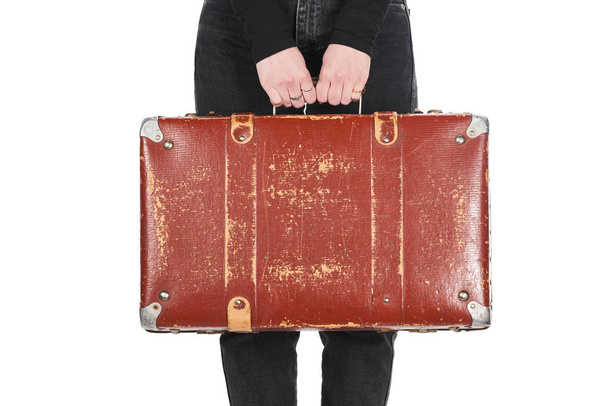 cropped view of woman in jeans holding vintage suitcase isolated on white - Фото, зображення