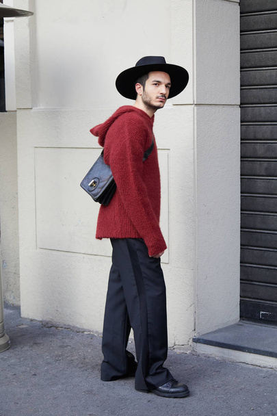 Man with dark red sweater and black hat before Daks fashion show, Milan Fashion Week street style on January 14, 2018 in Milan. - Фото, изображение