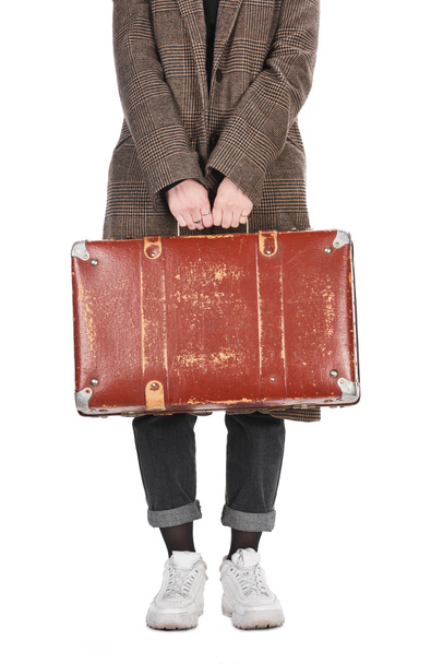 cropped view of woman in plaid coat holding vintage weathered suitcase isolated on white - Photo, Image