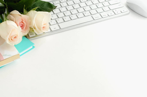 rose flowers, keyboard and notebooks on white tabletop - Fotografie, Obrázek