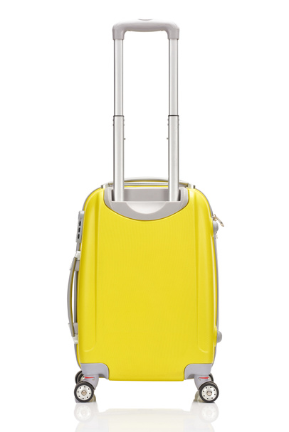 back view of yellow plastic wheeled colorful suitcase with handle isolated on white - Foto, Imagem