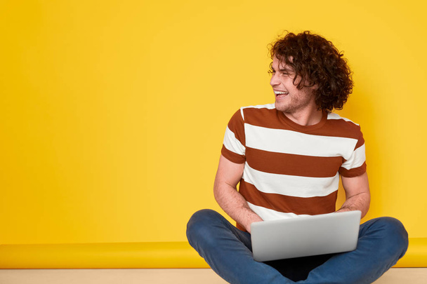 Cheerful male student using laptop - Foto, Imagem