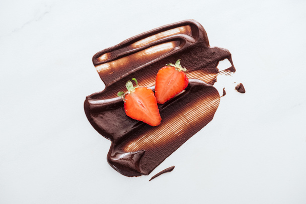 Top view of strawberries with liquid chocolate on white background - Photo, Image