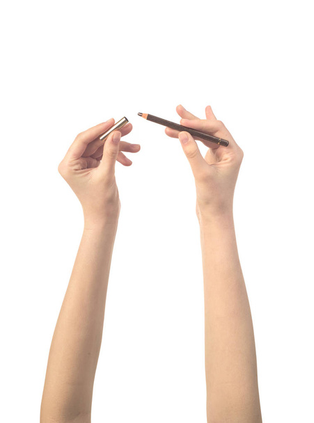 make up pencil in womens hand isolated - 写真・画像