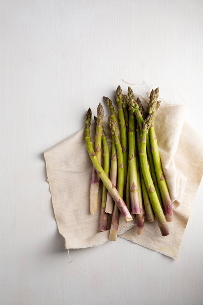 Bunch of asparagus on white top view - Zdjęcie, obraz