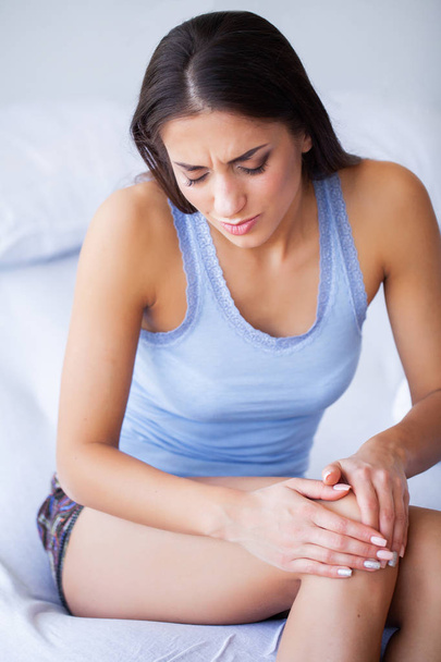 Body Pain. Beautiful Woman With Painful Knee, Feeling Leg Pain - Photo, Image