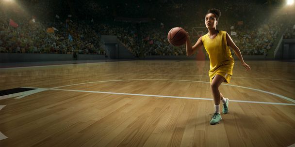 Γυναίκα παίκτης μπάσκετ με μπάλα σε μεγάλο επαγγελματικό αρένα  - Φωτογραφία, εικόνα