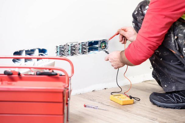 electrician at work, home renovation, electrical installation, Hand of an electrician, handyman at work - Photo, Image