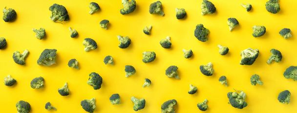 Creative layout of fresh broccoli on yellow paper background. Top view. Food pattern in minimal style. Flat lay. Banner - Fotoğraf, Görsel
