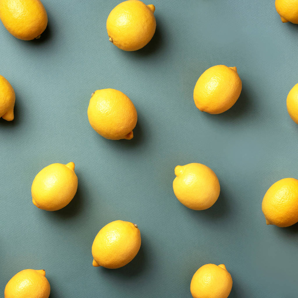Food pattern with lemons on green paper background. Top view. Summer concept. Vegan and vegetarian diet. Square crop - 写真・画像