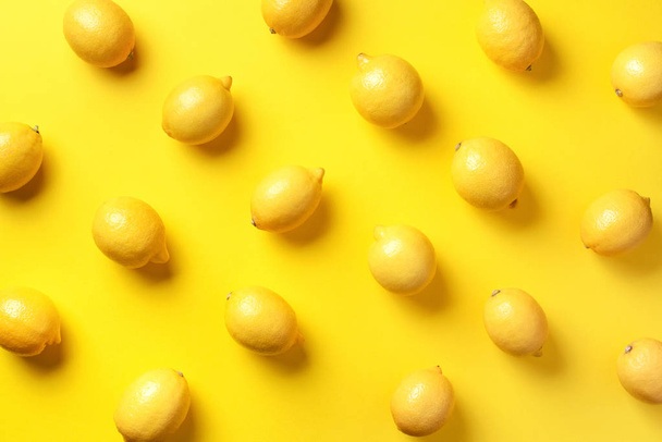 Food pattern with lemons on yellow paper background. Top view. Summer concept. Vegan and vegetarian diet - 写真・画像