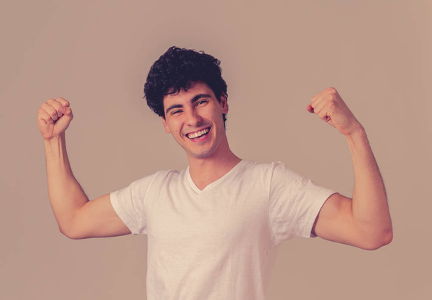 Portrait of young man celebrating achievement, a football goal, wining the lottery or having great success, shouting and gesturing in happiness. In face expression and Positive human emotions. - Fotoğraf, Görsel