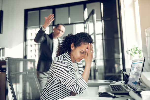 Employee having headache listening to angry boss - Zdjęcie, obraz