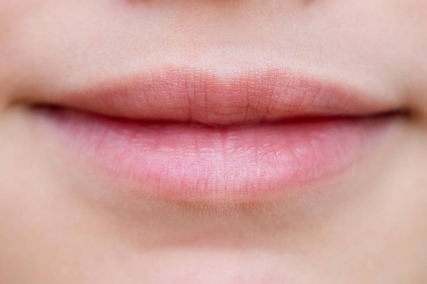 Part of face, young woman close up. Plump lips without makeup - Foto, Imagem