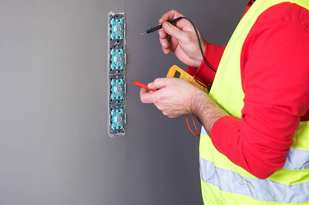 electrician at work, home renovation, electrical installation, Hand of an electrician, handyman at work - Photo, image